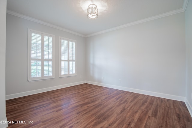 unfurnished room featuring ornamental molding and dark hardwood / wood-style flooring