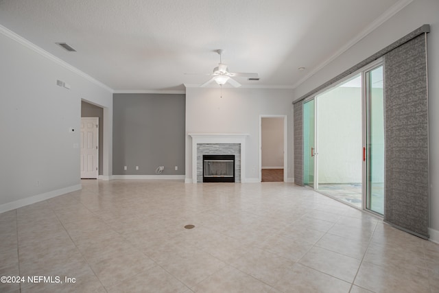 unfurnished living room featuring crown molding, ceiling fan, a textured ceiling, and a wealth of natural light