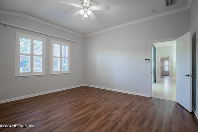 spare room featuring ornamental molding, plenty of natural light, and dark hardwood / wood-style floors