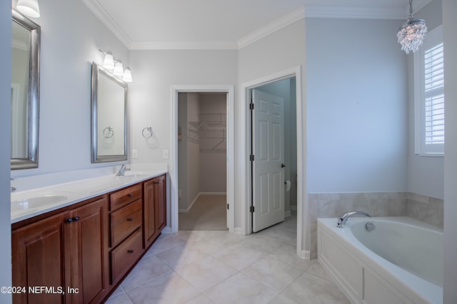 bathroom featuring ornamental molding, a washtub, tile patterned floors, and vanity