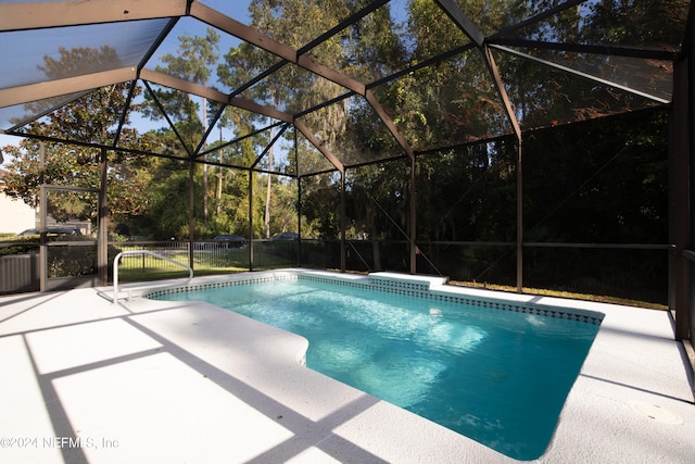 view of pool featuring a patio and a lanai