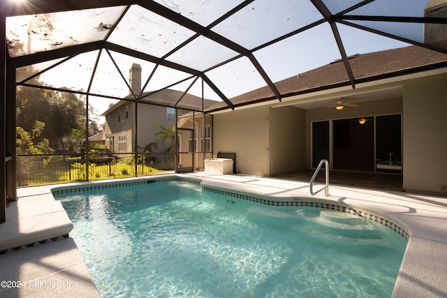 view of pool featuring ceiling fan, a lanai, and a patio area