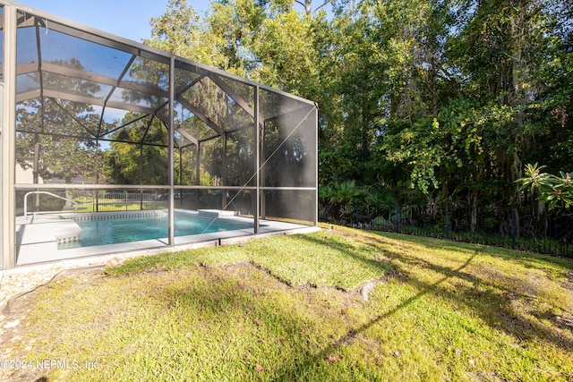 view of swimming pool featuring a yard and a lanai