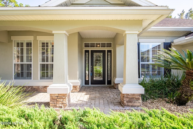 view of exterior entry featuring a porch