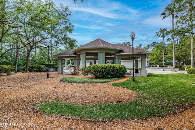 view of front of property featuring a gazebo and a front yard