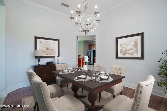 dining room featuring ornamental molding, dark hardwood / wood-style floors, and a chandelier