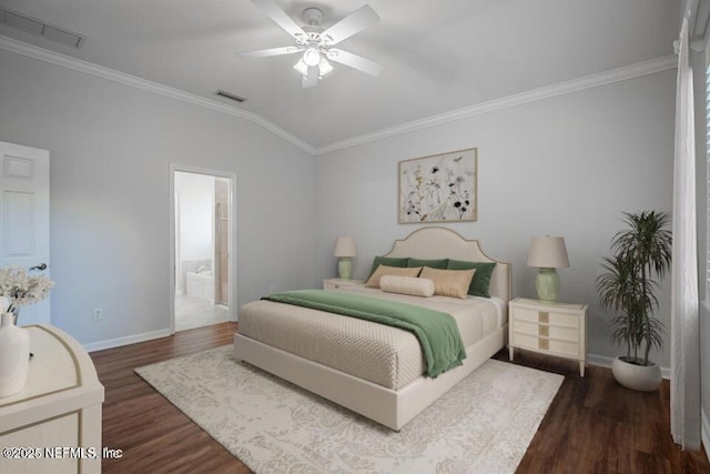 bedroom with lofted ceiling, ornamental molding, dark hardwood / wood-style flooring, and ensuite bathroom