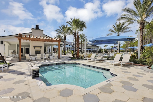 view of swimming pool featuring a pergola and a patio