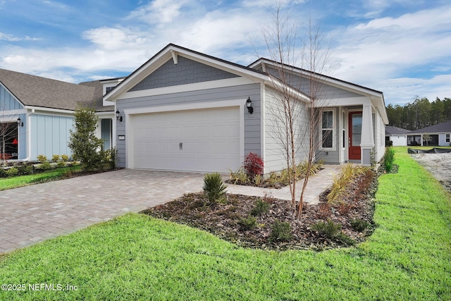 view of front facade with a garage and a front lawn