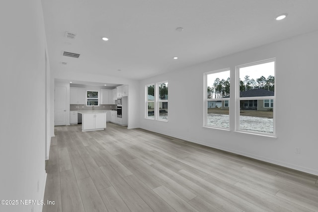 unfurnished living room featuring light hardwood / wood-style flooring