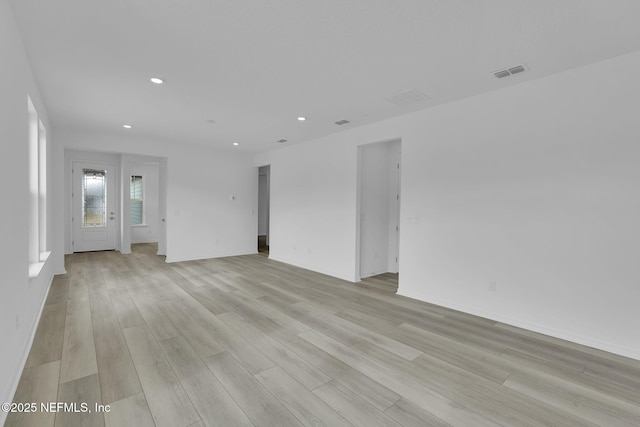 unfurnished room with light wood-type flooring