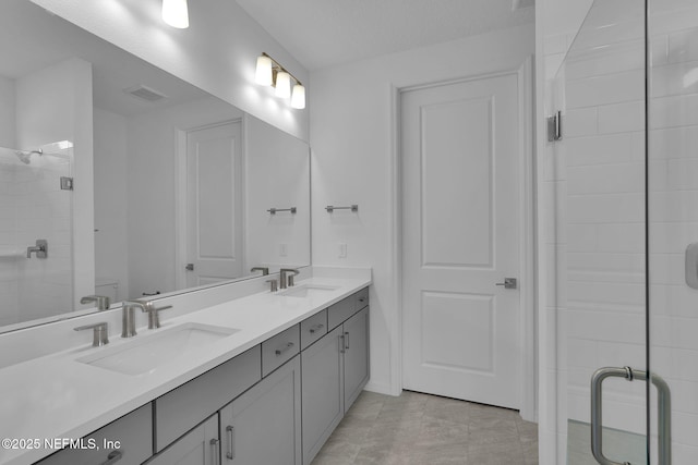 bathroom featuring vanity and a shower with door