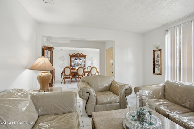 living room with light tile patterned flooring and a textured ceiling