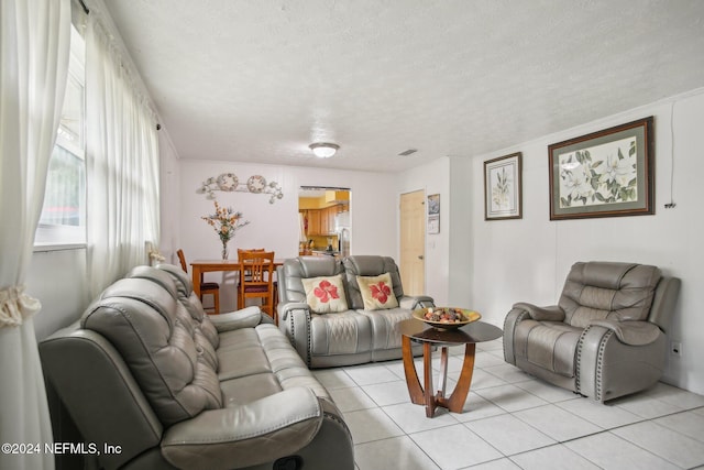 tiled living room with a textured ceiling