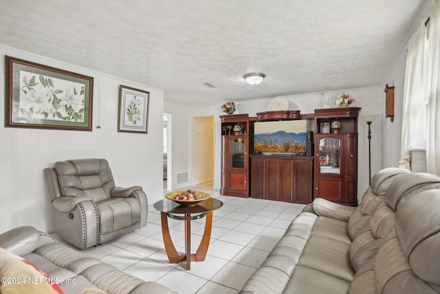 living room with light tile patterned floors and a textured ceiling