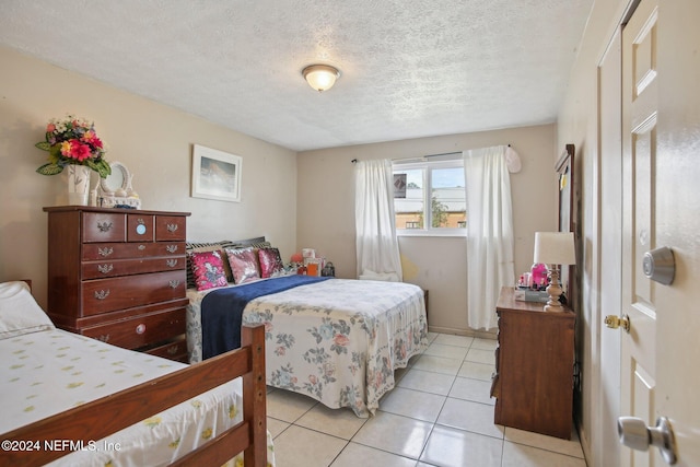 tiled bedroom with a textured ceiling