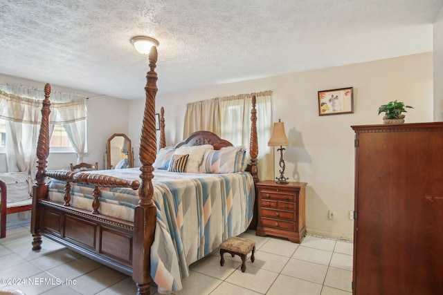 tiled bedroom with a textured ceiling