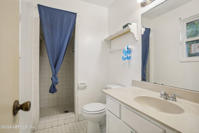 bathroom featuring tile patterned flooring, a shower with curtain, toilet, and vanity