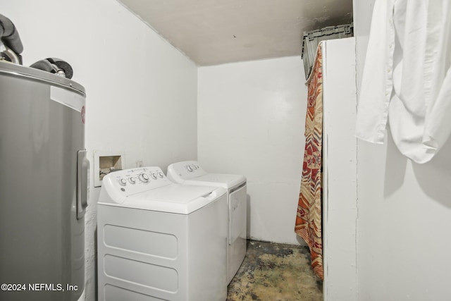 clothes washing area featuring washing machine and dryer and electric water heater