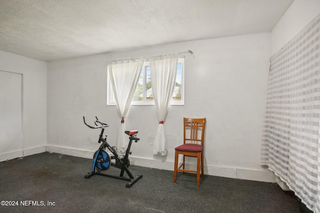 workout room with a textured ceiling