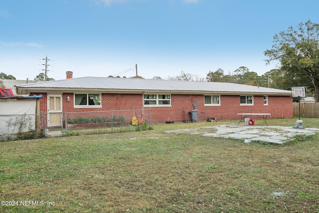 back of property featuring a yard and a patio area