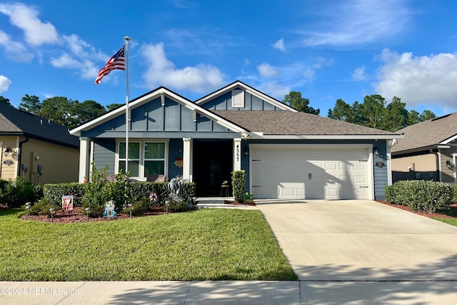 view of front of home with a front yard and a garage