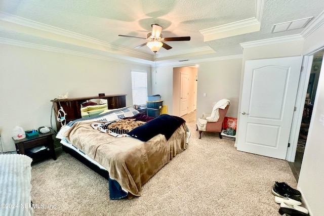 bedroom with ceiling fan, a raised ceiling, and carpet flooring