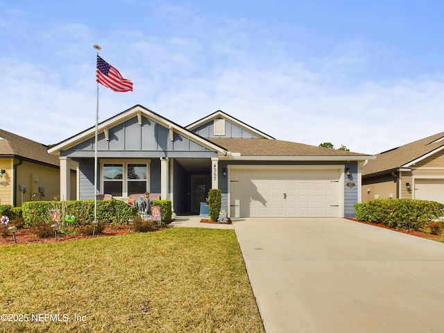 view of front of property with a garage, concrete driveway, board and batten siding, and a front yard