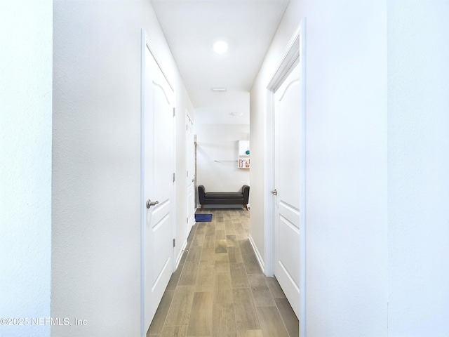 corridor featuring wood finished floors