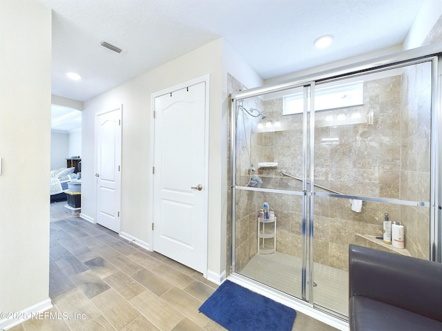 ensuite bathroom featuring ensuite bath, visible vents, baseboards, and a shower stall