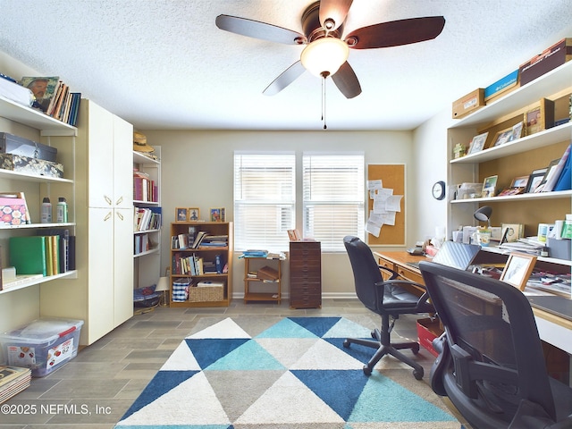 office area with a ceiling fan, wood tiled floor, and a textured ceiling