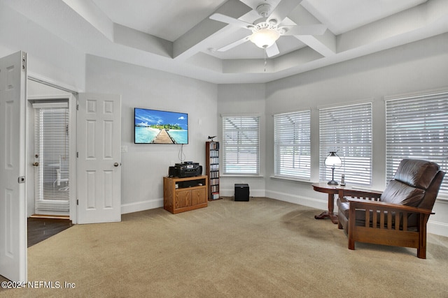 sitting room with coffered ceiling, light carpet, and ceiling fan