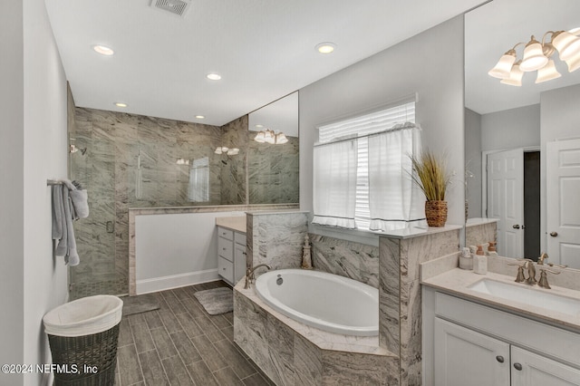 bathroom with vanity, separate shower and tub, and hardwood / wood-style floors