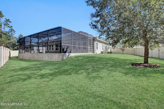 view of yard with glass enclosure