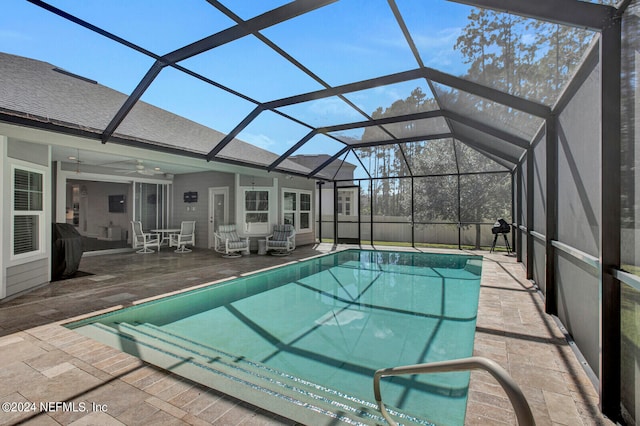 view of pool featuring ceiling fan, a lanai, and a patio area