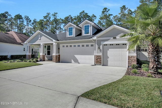 view of front of home with a front yard and a garage