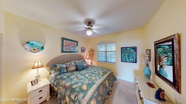 carpeted bedroom with baseboards and ceiling fan