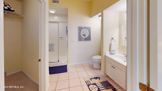 full bath with visible vents, a shower stall, toilet, tile patterned floors, and vanity