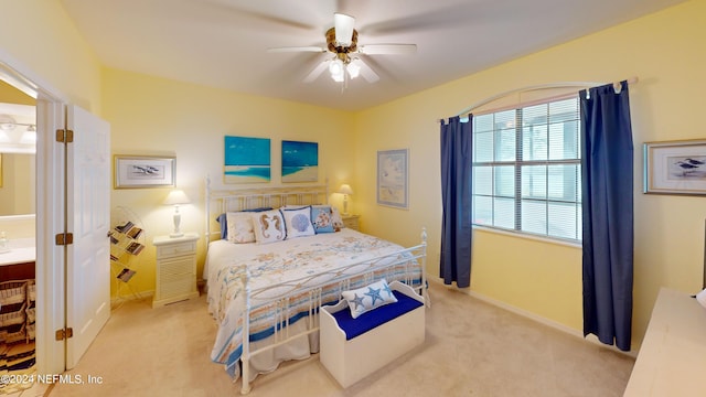 bedroom with a ceiling fan, light colored carpet, and baseboards