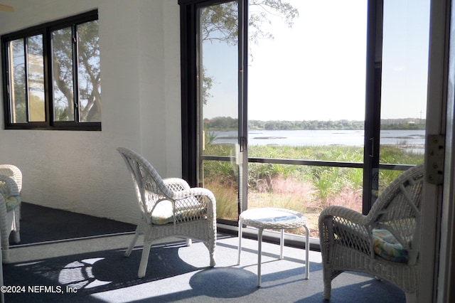 sunroom / solarium with a wealth of natural light and a water view