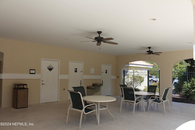 dining room with a ceiling fan and finished concrete floors