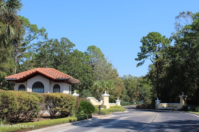 view of street featuring curbs and a gated entry