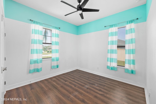 empty room featuring ceiling fan and dark hardwood / wood-style flooring