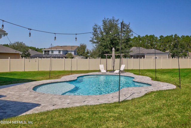 view of swimming pool with a lawn and a patio