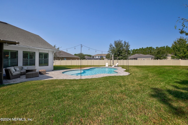 view of swimming pool featuring a lawn and a patio area