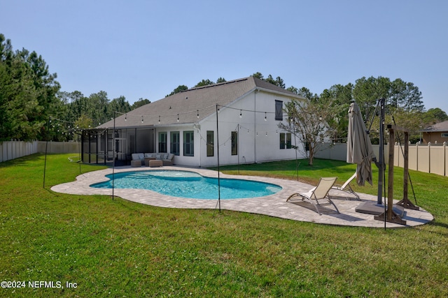 view of swimming pool with outdoor lounge area, a yard, and a patio