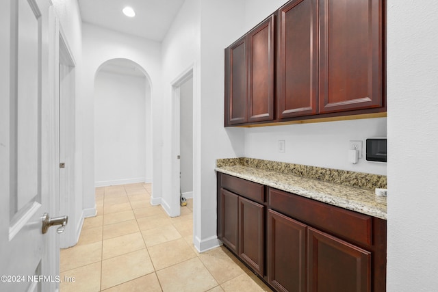 interior space featuring light stone counters and light tile patterned flooring