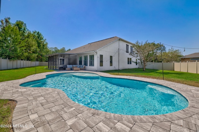 view of swimming pool featuring a patio area, a sunroom, and a yard