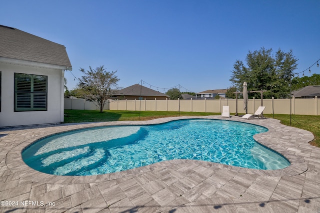 view of pool featuring a yard and a patio