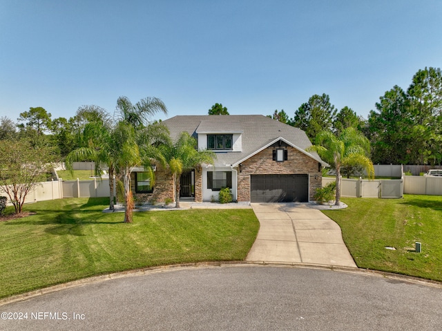 view of front of house with a front yard and a garage